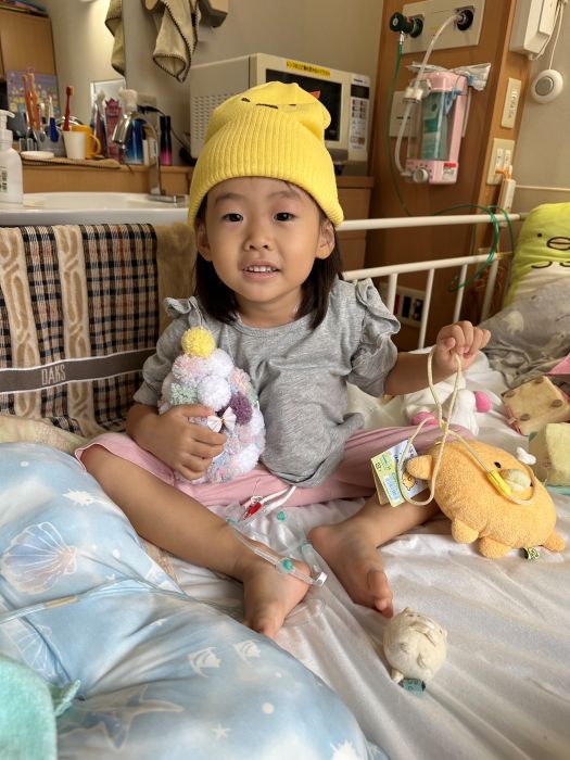 入院中のベッドの上でおもちゃを持つ笑舞ちゃん