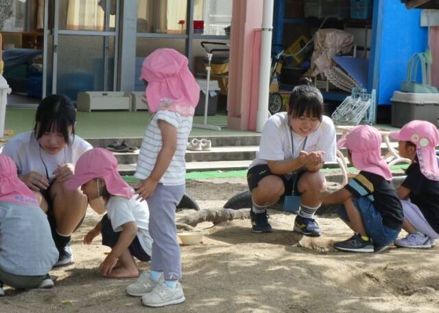 こども園で子どもたちと遊ぶ生徒2人