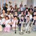 四日市吹奏楽団の団員たちが楽器を手に、第45回定期演奏会へ向け笑顔を見せる様子